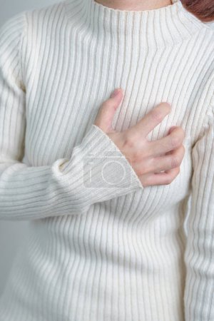 Foto de Woman hand holding chest ache. Heart disease, angina disease and symptom heart attack disease Cardiovascular, Atherosclerosis, Hypertensive world Heart day and health concept - Imagen libre de derechos