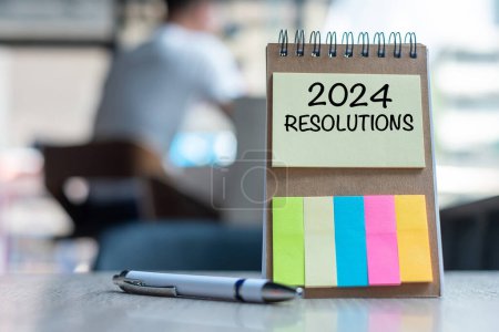 2024 Resolution word on note paper with pen on wooden table. strategy, solution, goal, business, New Year New You and happy holiday concepts