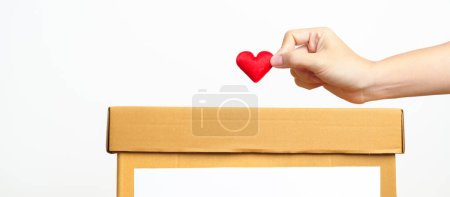 Organ Donation, Charity, Volunteer, Giving and blood Concept. Hand holding red heart into donate box for support poor, homeless, CSR social responsibility, world heart and  mental health day