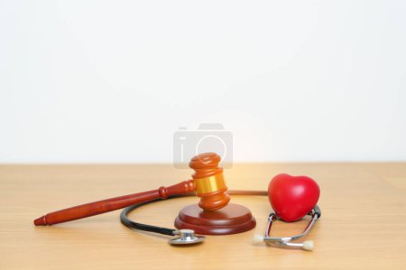 Photo for Gavel and stethoscope on table. Medical and Health Law, legal of medical malpractice concept - Royalty Free Image