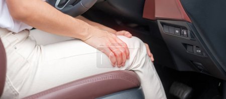 Téléchargez les photos : Femme avec son entorse au genou en voiture depuis longtemps, Syndrome de douleur patellofémorale, arthrose, arthrite, rhumatisme et tendinite patellaire. concept médical et ergonomique - en image libre de droit