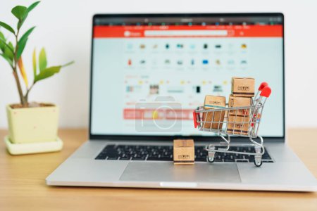 Photo for Boxes with shopping cart on a laptop computer. online shopping, Marketplace platform website, technology, ecommerce, shipping delivery, logistics and online payment concepts - Royalty Free Image