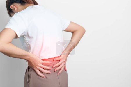 adult female with muscle pain on gray background. Elderly woman having back body ache due to Piriformis Syndrome, Low Back Pain and Spinal Compression. Office syndrome and medical concept
