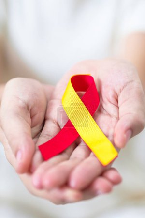 Photo for Woman holding Red and Yellow ribbon. World hepatitis day awareness month, 28 July, Liver cancer, Jaundice, Cirrhosis, Failure, Enlarged, Hepatic Encephalopathy and Health concept - Royalty Free Image