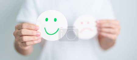 Photo for Woman show Happy Smile face paper, Mental health Assessment, Psychology, Health Wellness, Feedback, Customer Review, Experience, Satisfaction Survey, Positive Thinking and World Mental Health day - Royalty Free Image