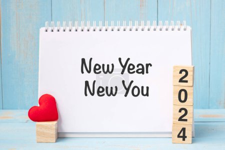 Photo for New Year New You words and 2024 cubes with red heart shape decoration on blue wooden table background. Goal, Resolution, health, Love a - Royalty Free Image