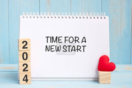 Photo for Time for A New Start words and 2024 cubes with red heart shape decoration on blue wooden table background. New Year NewYou, Goal, Resolution, health, Love - Royalty Free Image