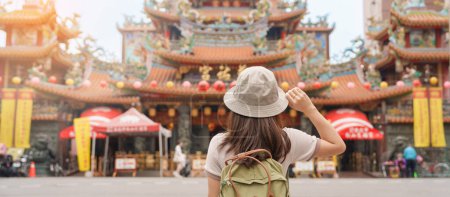 Téléchargez les photos : Femme voyageuse visitant Taïwan, visites touristiques dans le temple Songshan Ciyou, près du marché nocturne de Raohe, district de Songshan, ville de Taipei. repère et populaire. Voyage et vacances concept - en image libre de droit