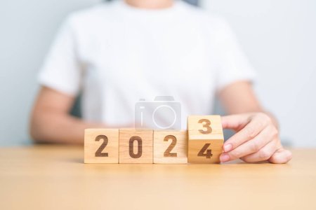 Photo for 2023 change to 2024 year block on table. goal, Resolution, strategy, plan, start, budget, mission, action, motivation and New Year concepts - Royalty Free Image
