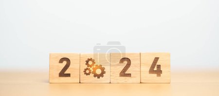 Photo for 2024 block with gear icon. Business Process, Team, teamwork, Goal, Target, Resolution, strategy, plan, Action, motivation, change, brainstorm and New Year start concepts - Royalty Free Image