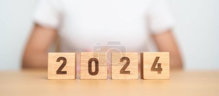 Photo for 2024 year block on table. goal, Resolution, strategy, plan, start, budget, mission, action, motivation and New Year concepts - Royalty Free Image