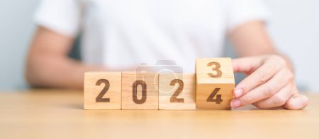 Photo for 2023 change to 2024 year block on table. goal, Resolution, strategy, plan, start, budget, mission, action, motivation and New Year concepts - Royalty Free Image