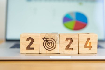 Photo for 2024 Year block with dartboard icon against computer laptop background. Goal, Target, Resolution, strategy, plan, Action, mission, motivation, and New Year start concepts - Royalty Free Image