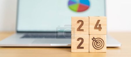 Photo for 2024 Year block with dartboard icon against computer laptop background. Goal, Target, Resolution, strategy, plan, Action, mission, motivation, and New Year start concepts - Royalty Free Image