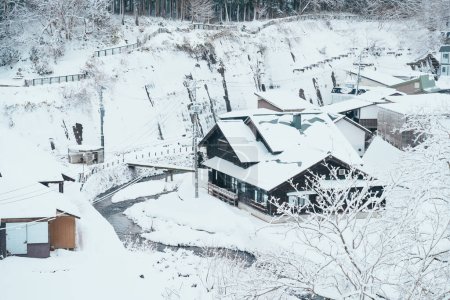Photo for Beautiful view of Ginzan Onsen village with snow fall in winter season is most famous Japanese Hot Spring in Yamagata, Japan. - Royalty Free Image