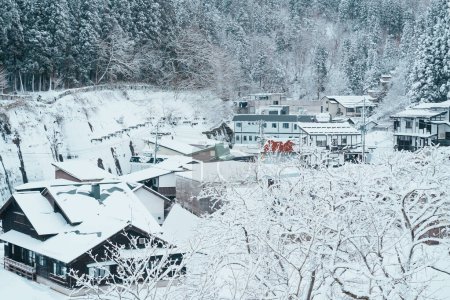 Photo for Beautiful view of Ginzan Onsen village with snow fall in winter season is most famous Japanese Hot Spring in Yamagata, Japan. - Royalty Free Image