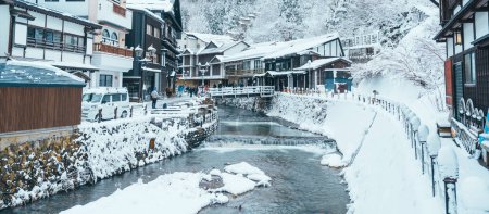 Photo for Beautiful Ginzan Onsen with snow fall in winter season is most famous Japanese Hot Spring in Yamagata, Japan. - Royalty Free Image