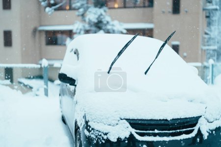 Photo for Car park at Ginzan Onsen with snow fall in winter season is most famous Japanese Hot Spring in Yamagata, Japan. - Royalty Free Image