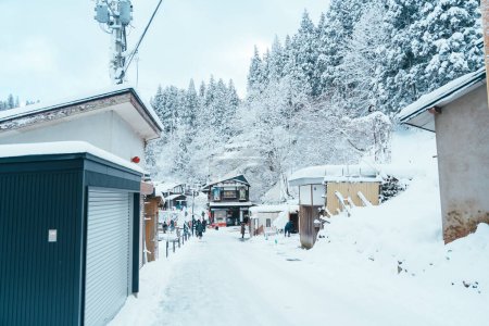Photo for Bus stop at Ginzan Onsen for Oishida station with snow fall in winter season is most famous Japanese Hot Spring in Yamagata, Japan. Yamagata, Japan, 24 January 2024 - Royalty Free Image