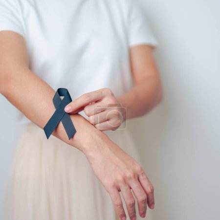 Photo for Melanoma and skin cancer, Vaccine injury awareness month and rest in peace concepts. woman holding black Ribbon - Royalty Free Image