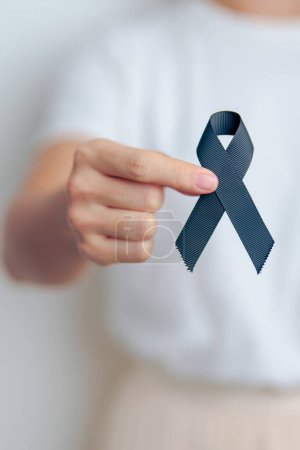 Melanoma and skin cancer, Vaccine injury awareness month and rest in peace concepts. woman holding black Ribbon