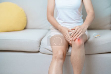 Photo for Arthritis and Muscle Pain Relief Cream concept. woman having knee ache and muscle pain due to Runners Knee or Patellofemoral Pain Syndrome, osteoarthritis, rheumatism and Patellar Tendinitis - Royalty Free Image