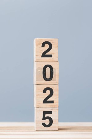 Photo for Wooden cube block with 2025 text on table background. Resolution, plan, review, goal, start and New Year holiday concepts - Royalty Free Image