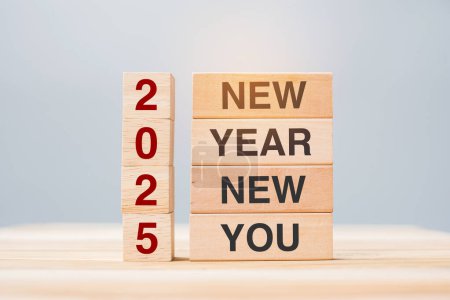 Photo for Hand holding wooden block with text 2025 NEW YEAR NEW YOU on table background. Resolution, strategy, goal, business and holiday concepts - Royalty Free Image