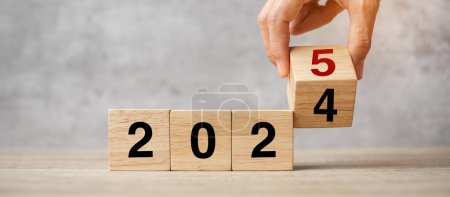 Photo for Hand flipping block 2024 to 2025  text on table. Resolution, strategy, plan, goal, motivation, reboot, business and New Year holiday concepts - Royalty Free Image