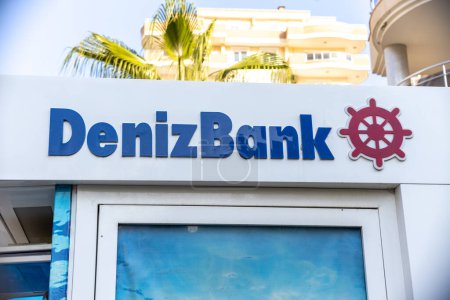 Foto de Alanya, Turkey - 21 July 2021: Deniz Bank logo on a shore city residence building with an ATM. - Imagen libre de derechos