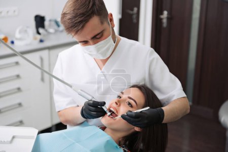 Photo for Woman receiving a dental treatment - Royalty Free Image
