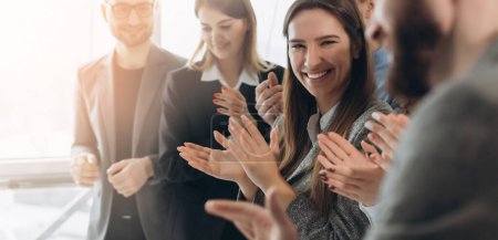 Photo for Great job! Successful business team is clapping their hands in modern workstation, celebrating the performance of new product - Royalty Free Image
