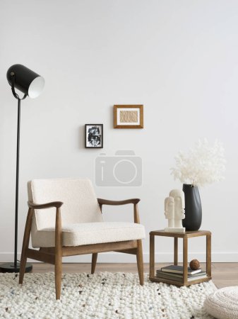 Photo for Domestic and cozy composition a living room interior with mock up poster, beige armchair, coffee table, lamp, vase with dried flowers and personal accessories. Home decor. Template. - Royalty Free Image