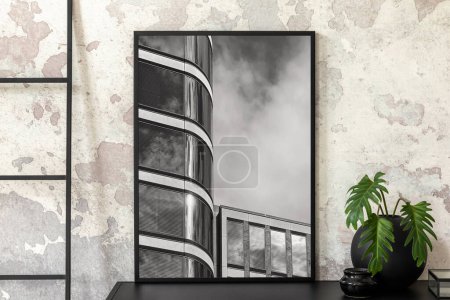 Photo for Interior design of indiustral apartment with mock up poster frame, simple rack, round vase with leaves, box, stylish bowl, ladder, gray concrete wall and personal accessories. Home decor. Template. - Royalty Free Image