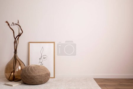 Photo for Aesthetic interior of living room with copy space, poster, glass vase boho pouf, carpet and personal accessories. Minimalist home decor. Template - Royalty Free Image