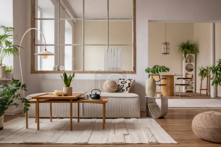 Téléchargez les photos : Creative composition of living room interior with modular sofa, beige rug, plants, vase with green leaves, pouf, stylish coffee table, big window, lamp and personal accessories. Home decor. Template. - en image libre de droit