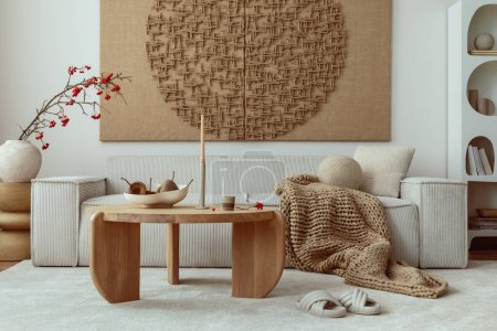Photo for Interior design of japandi living room with mock up poster frame, modular beige sofa, vase with rowan, round wooden coffee table, braided brown plaid and personal accessories. Home decor. Template. - Royalty Free Image