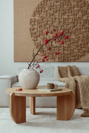 Photo for Aesthetic composition of living room interior with mock up poster,  modular beige sofa, round coffee table, rug, pouf, bowl, vase with rowan, books and personal accessories. Home decor. Template. - Royalty Free Image