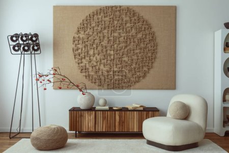 Photo for Interior design of living room interior with mock up poster frame, white armchair, wooden sideboard, sculpture, rug, vase with rowan, black modern lamp and personal accessories. Home decor. Template. - Royalty Free Image
