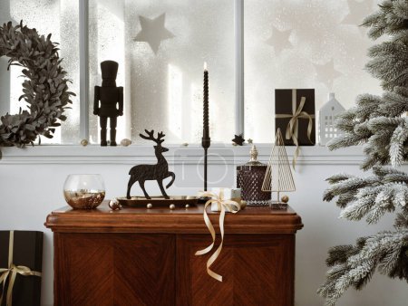 Creative christmas composition on the vintage shelf in the living room interior with beautiful decoration, big window, christmas tree, candles, stars, gifts, light and elegant accessories. Template.