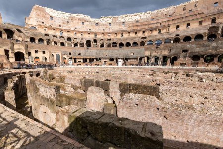 Photo for Rome, Italy - March 02, 2023: Tourists walking inside the Roman Colosseum in Rome, Italy - Royalty Free Image