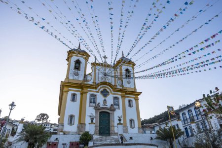 Photo for Facade of church of Our Lady of Conception decorated with flags for festivities. Ouro Preto, Minas Gerais state, Brazil - Royalty Free Image