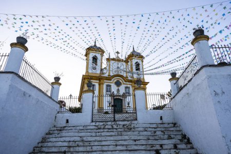 Photo for Facade of church of Our Lady of Conception decorated with flags for festivities. Ouro Preto, Minas Gerais state, Brazil - Royalty Free Image