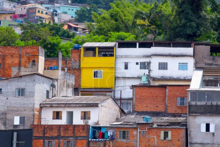View of shacks in a favela in the middle of the Atlantic Forest. Fragile buildings on the outskirts of Sao Paulo, Brazil.