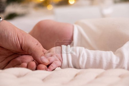 Photo for Dad's hand holds the hand of a newborn close-up, love and family, hand of a newborn, children - Royalty Free Image