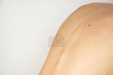 Photo for The back of a young thin girl on a white background without retouching and processing, body - Royalty Free Image