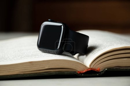 Photo for Dnipro, Ukraine - December 10, 2023: Apple Watch Series 8 lying on a book on the table at home, smart watch - Royalty Free Image
