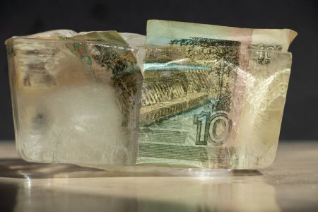 Ten Russian rubles in an ice cube close-up, frozen Russian money, sanctions