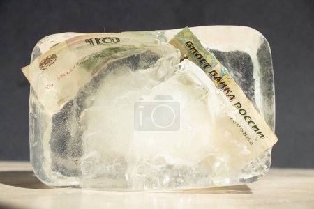 Ten Russian rubles in an ice cube close-up, frozen Russian money, sanctions