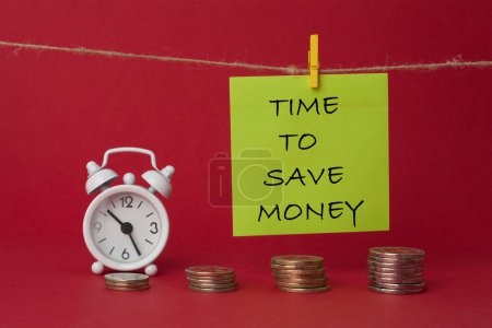 Photo for Time to save money text on note with alarm clock and coins. - Royalty Free Image